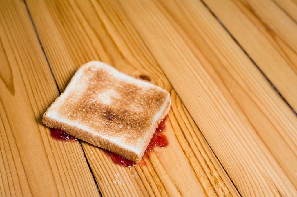 Slice-of-toast-with-strawberry-jam-upside-down-on-floor-2253524